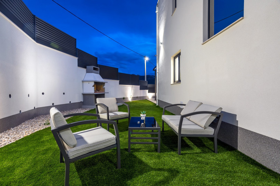 outdoor dining area with the traditional barbecue, a lounge corner next to it