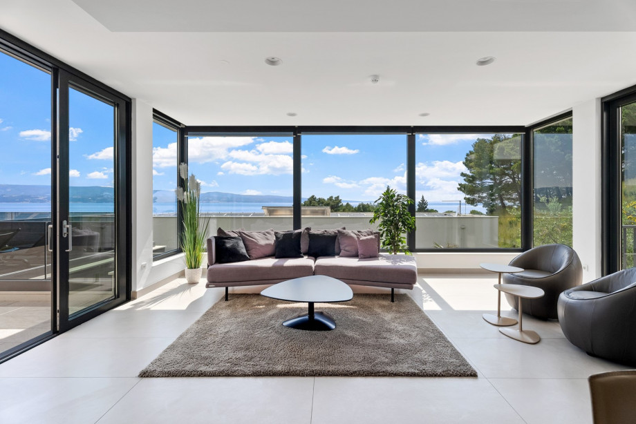 Living and dining area with opened sea views, fireplace,TV, fully equipped kitchen - ground floor