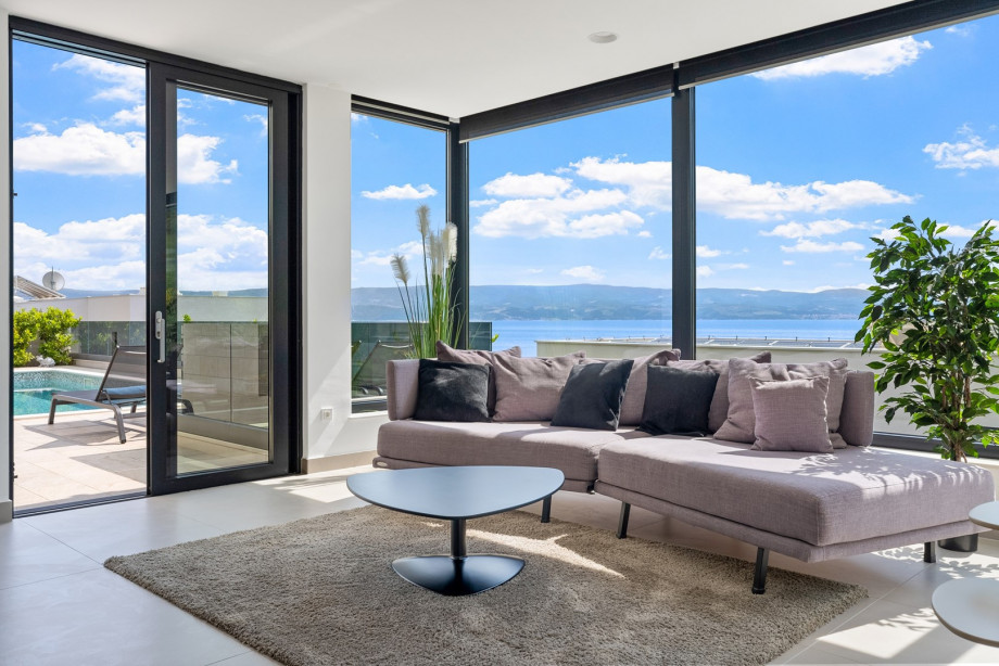 A very comfortable living room with sofas, TV, PS5,  all fully air-conditioned