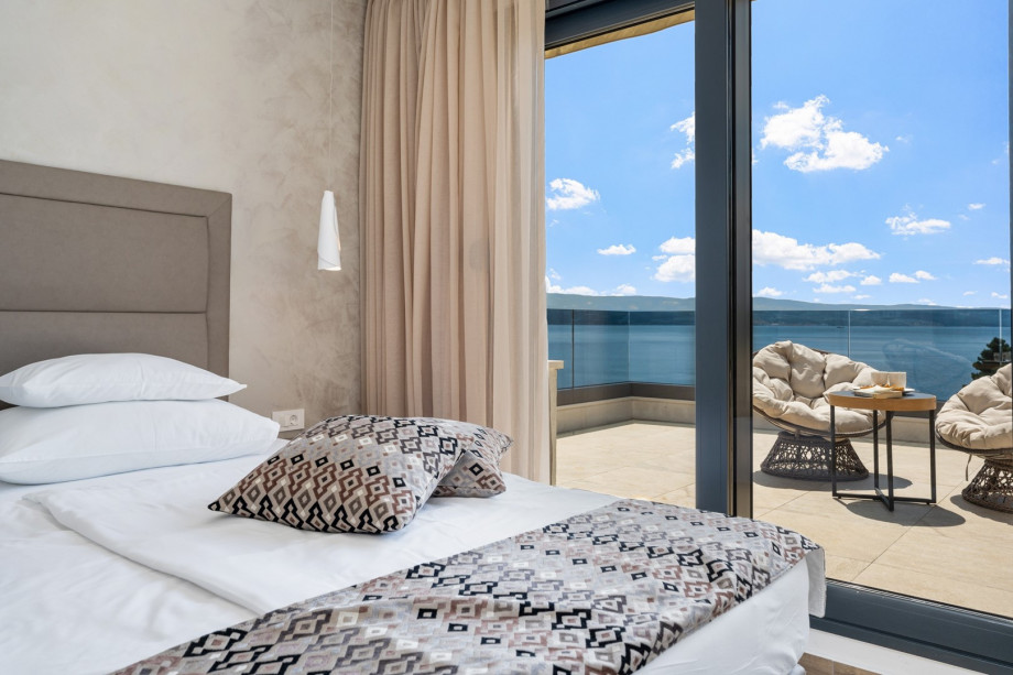 1 of 2 bedrooms that have exit to spacious terrace with comfortable furniture