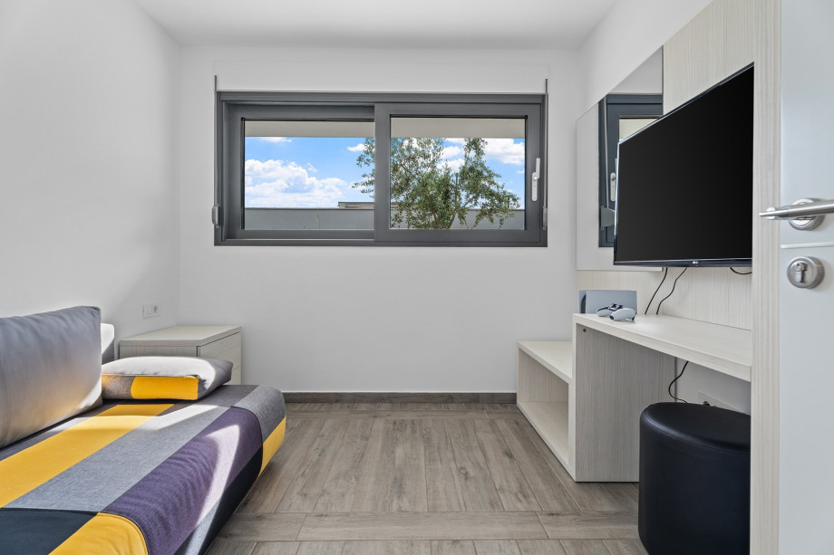 Small bedroom No5 with sofa bed and TV, at gym level