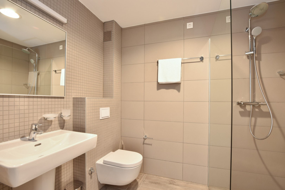 Bathroom with shower at gym and sauna area