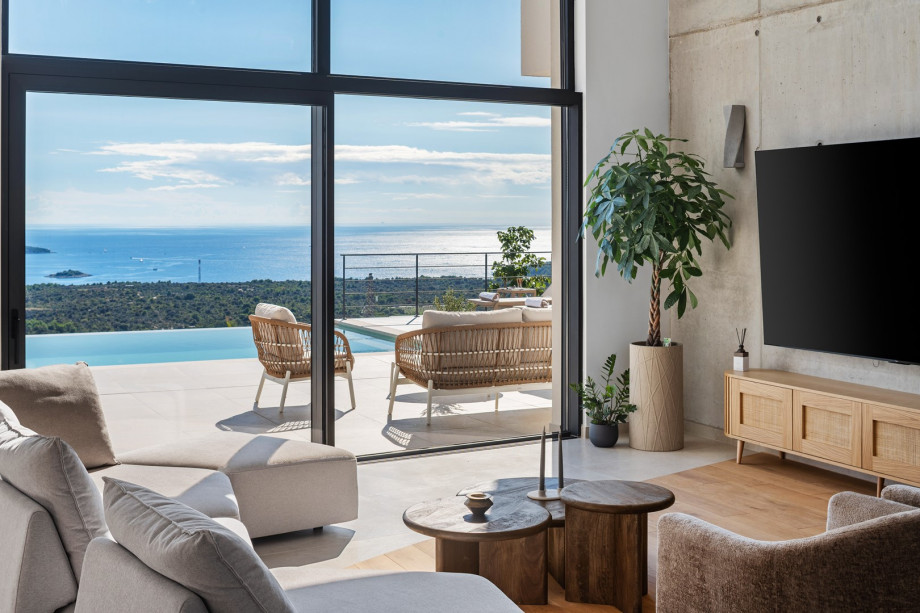 The entire villa is filled with full-length windows that seamlessly flow from the interior to the terraces