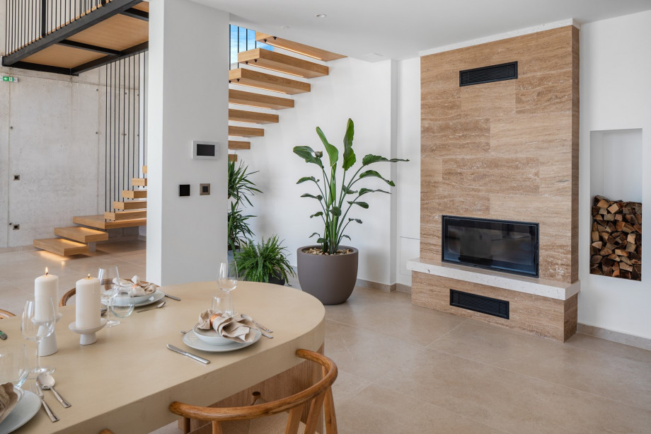 Living room with elegant sofas, a TV and surround system Bowers and Wilkins, a fireplace,