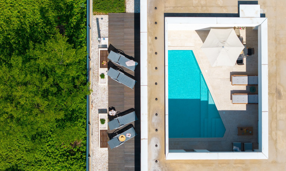 Villa Island Pearl is a contemporary architectural masterpiece that seamlessly blends modern design with natural beauty