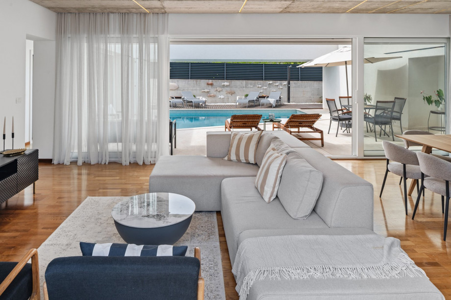 A spacious open-plan living room (49 sqm) with comfortable sofas and a smart TV