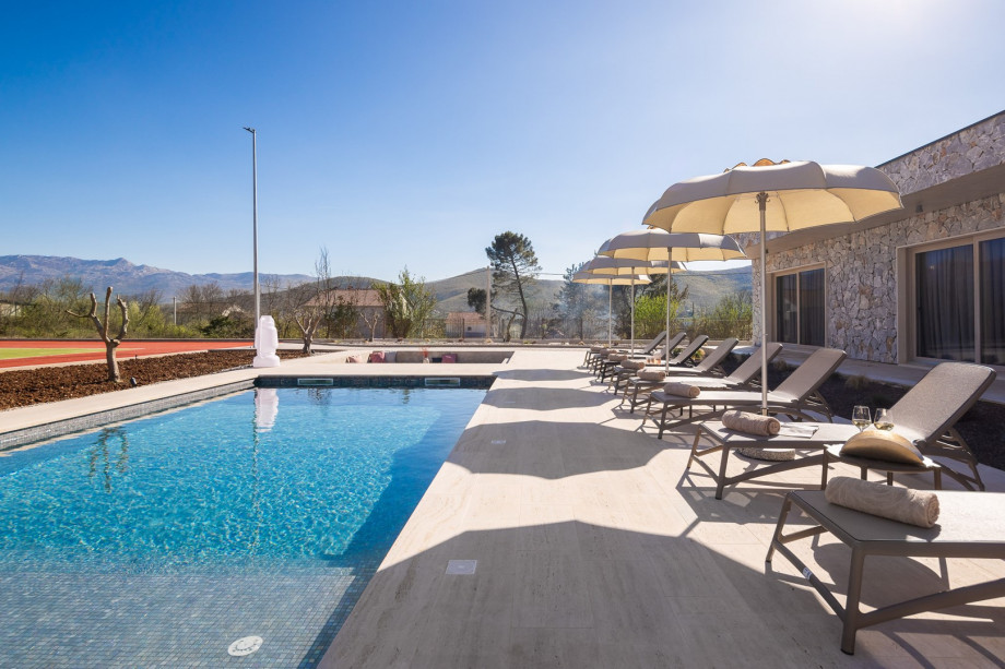 A sun deck area with 8 lounge chairs and umbrellas provides the perfect spot to relax