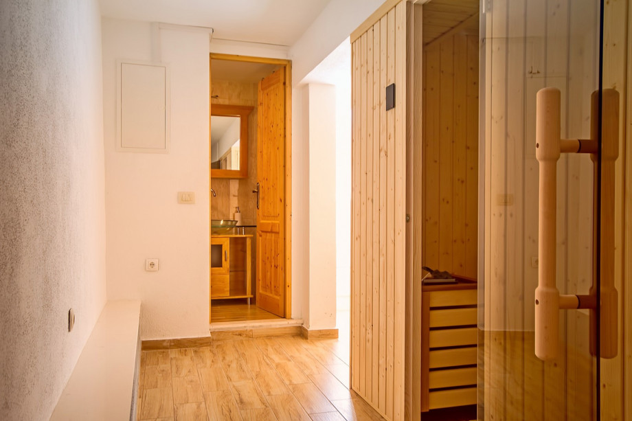 There is a Sauna and a bathroom with a shower next to the summer kitchen