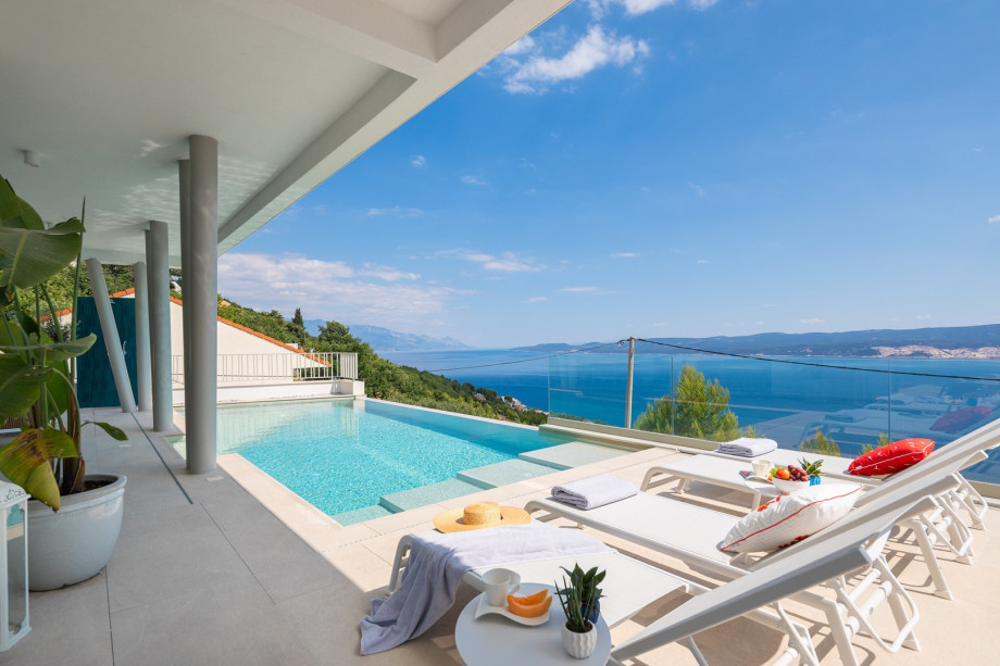 sun deck area (29sqm) with eight deck chairs, a lounge corner, and an outdoor shower