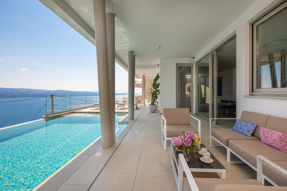 sun deck area (29sqm) with eight deck chairs, a lounge corner, and an outdoor shower