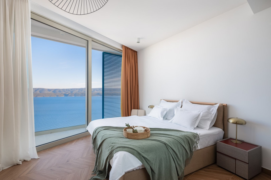 Bedroom NO1 (19 sqm) a king-size bed, a TV, an attached bathroom with a shower, and a balcony.