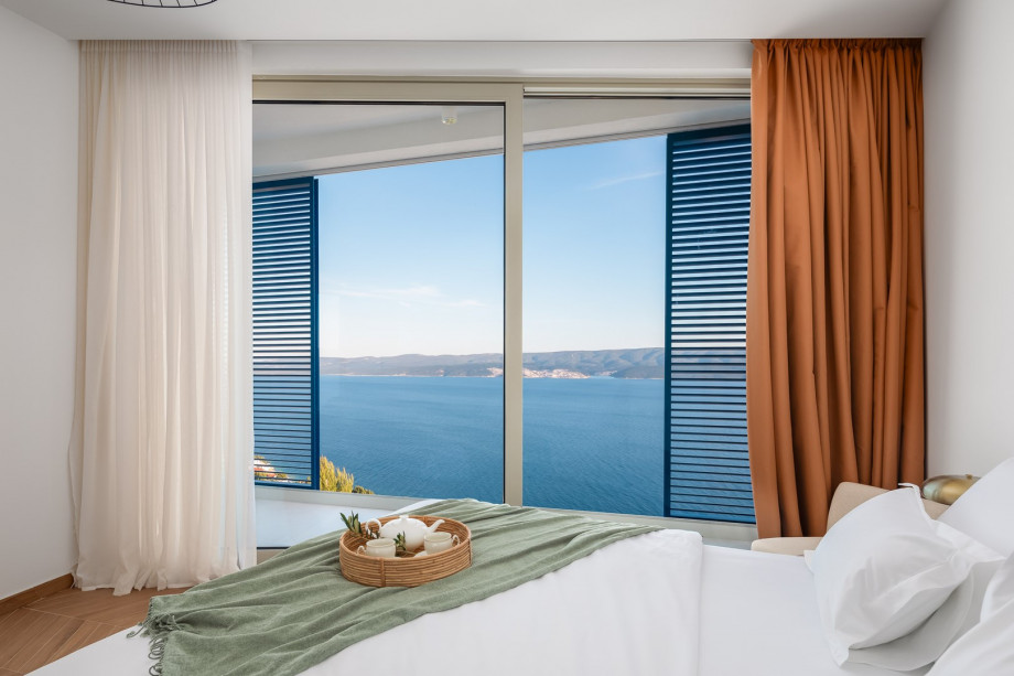 Bedroom NO1 (19 sqm) a king-size bed, a TV, an attached bathroom with a shower, and a balcony.