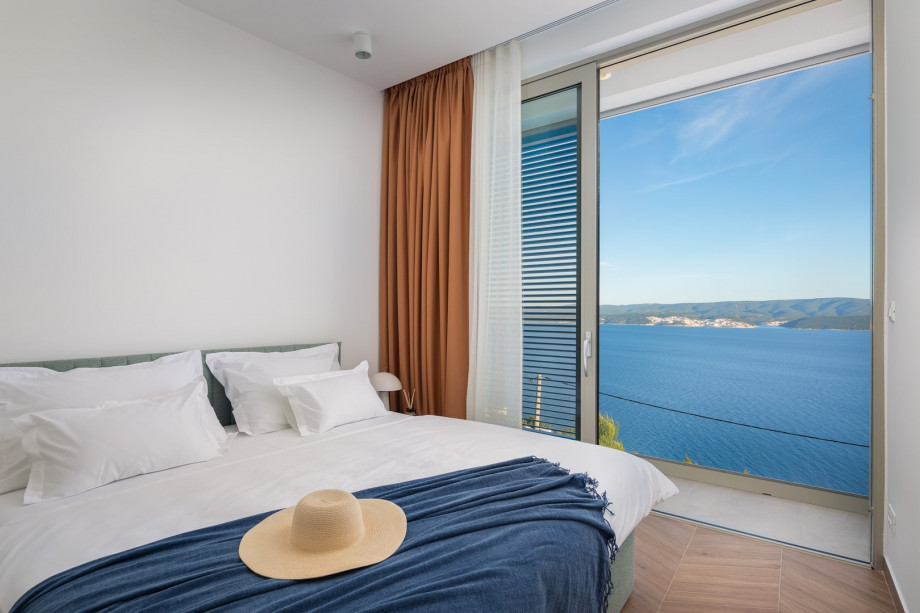 Bedroom NO2 (10 sqm) a king-size bed, a TV, an attached bathroom with a shower, and a balcony.