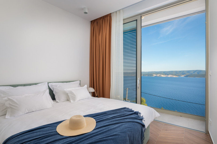 Bedroom NO2 (10 sqm) a king-size bed, a TV, an attached bathroom with a shower, and a balcony.