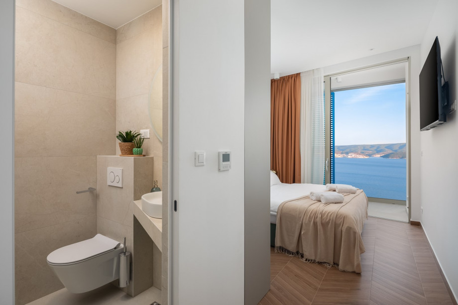 Bedroom NO4 (11 sqm) a king-size bed, a TV, an attached bathroom with a shower, and a balcony.