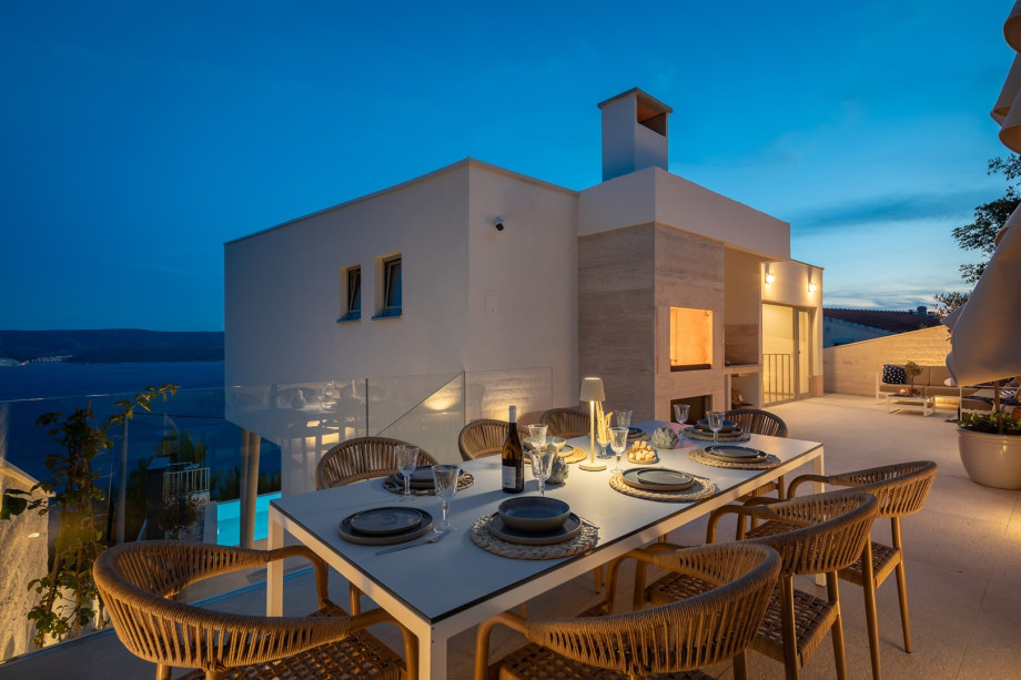 a shaded dining area for eight people, and a barbeque (woods/charcoal)