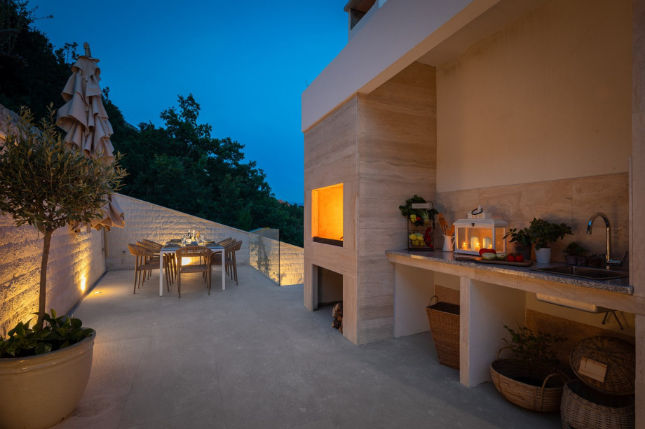 a shaded dining area for eight people, and a barbeque (woods/charcoal)