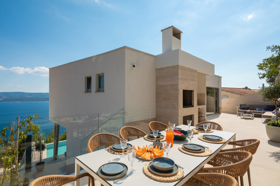 a shaded dining area for eight people, and a barbeque (woods/charcoal)