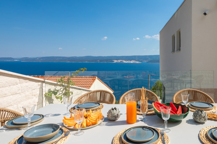 a shaded dining area for eight people, and a barbeque (woods/charcoal)