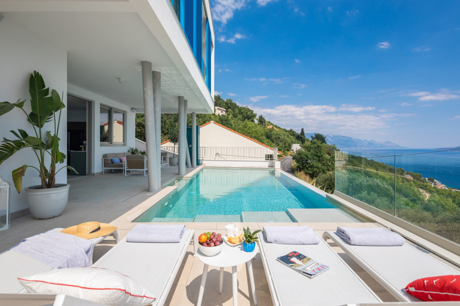 sun deck area (29sqm) with eight deck chairs, a lounge corner, and an outdoor shower