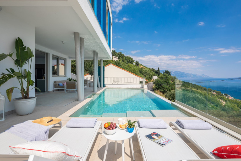 sun deck area (29sqm) with eight deck chairs, a lounge corner, and an outdoor shower