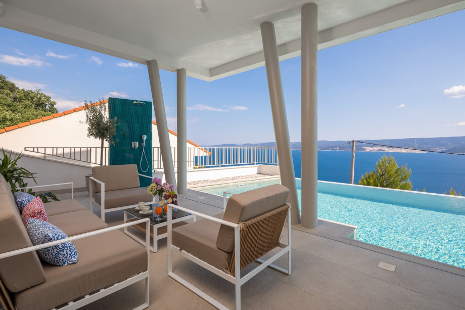 sun deck area (29sqm) with eight deck chairs, a lounge corner, and an outdoor shower