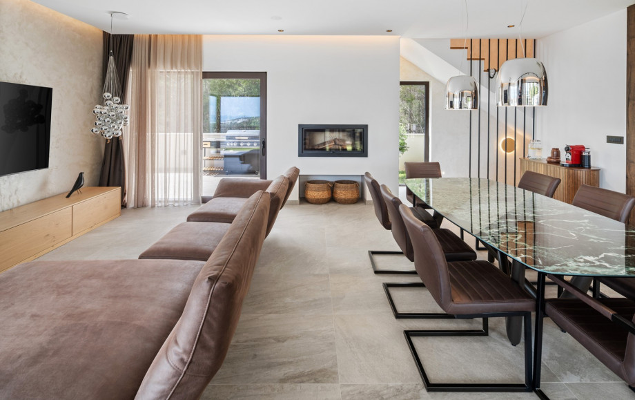 The ground floor features a spacious living area with breathtaking sea views,