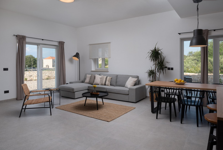 A living room with a comfy sofa, flat-screen TV with IPTV channels, free WiFi, and a beautiful fireplace.