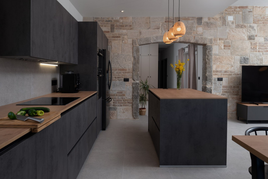 A dining table for 6 people a kitchen island with two bar stools, all with direct exits toward the pool area