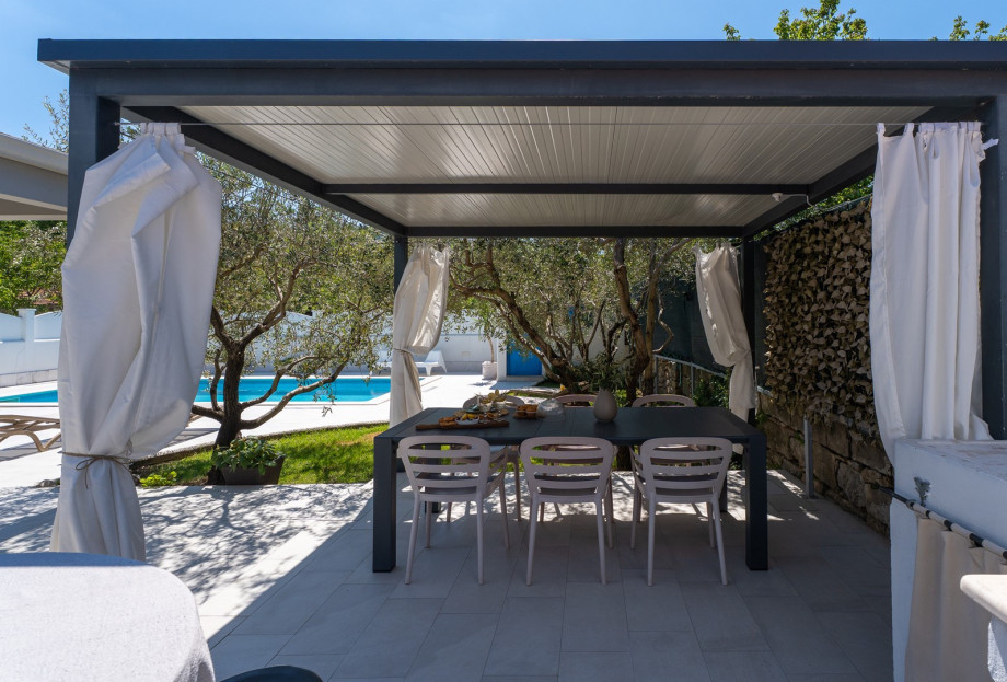 A spacious outdoor dining area with a barbecue (woods / charcoal)