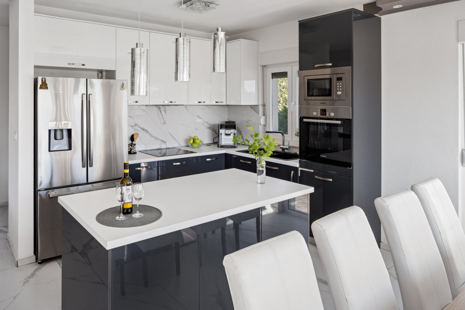 The modern kitchen contains such cooler, microwave, coffee maker, toaster, and kettle.
