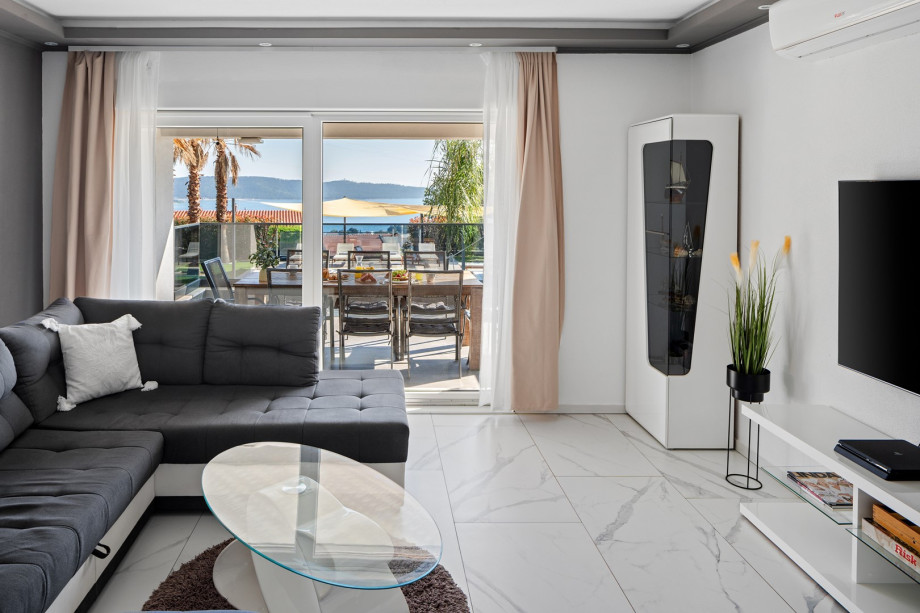 The stylish living area and direct access to the pool and outdoor dining area.