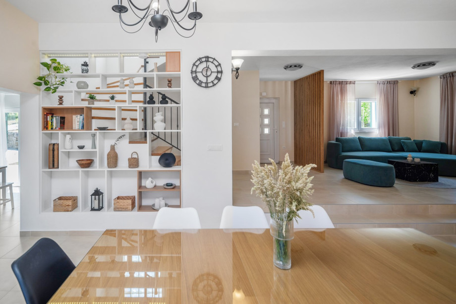 The ground floor features an air-conditioned living room equipped with a sofa and a TV.