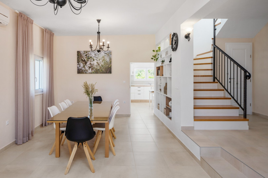 The space is brightened by natural light that streams in through large windows and glass doors.