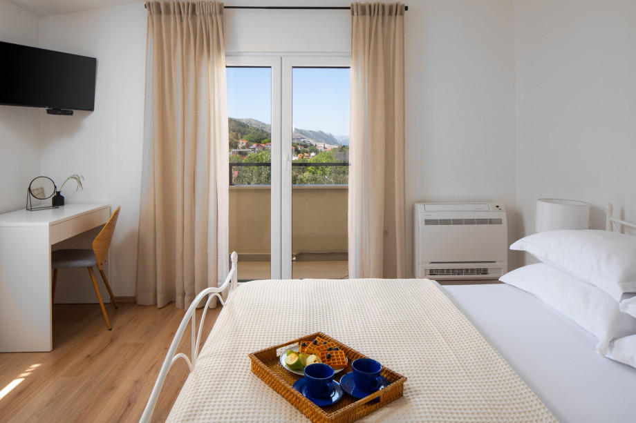 Wake up to lush green views from your private balcony, and unwind in comfort after a day of adventure.