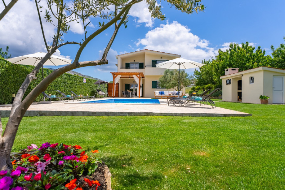 A spacious grass area featuring multiple recreational zones.