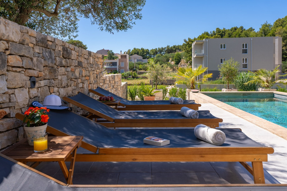 There is a sun deck area with 6 deck chairs, an outdoor shower, a covered outdoor dining area