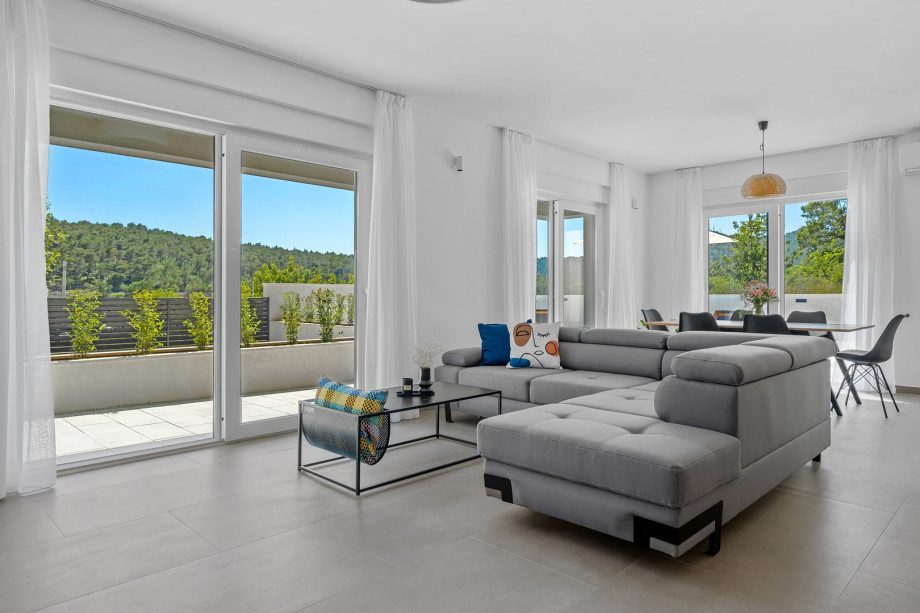 a stylish living area (42sqm) with flat screen TV, A/C, direct exit to outdoor dining area and pool