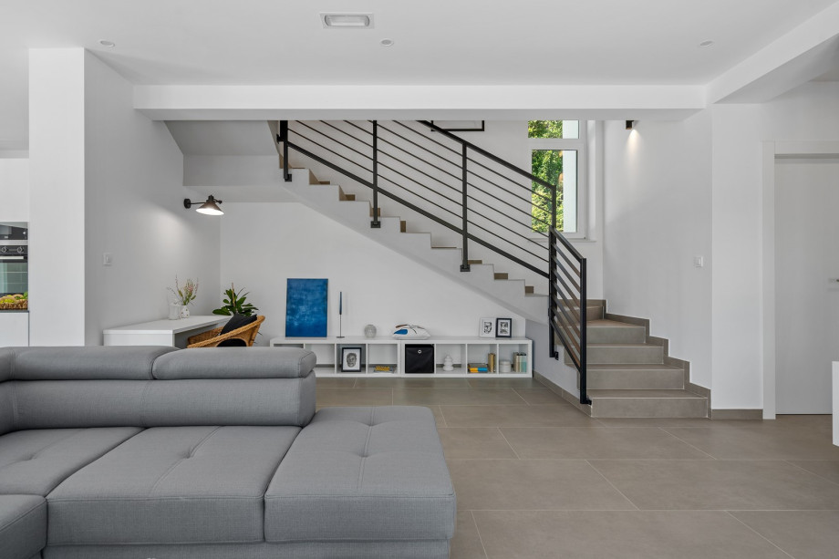 a stylish living area (42sqm) with flat screen TV, A/C, direct exit to outdoor dining area and pool