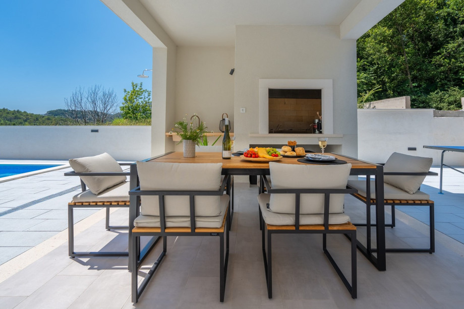 a covered dining area for 8 people