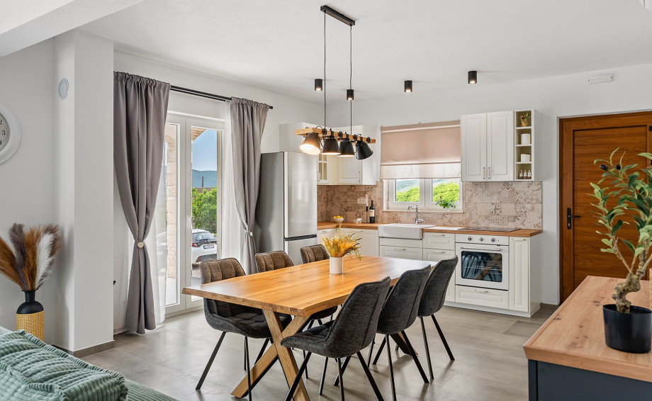 A large dining table that comfortably seats 8, ideal for family meals or enjoying the island’s fresh local produce