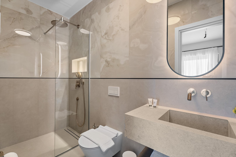 Private bathroom with a shower, towels are provided