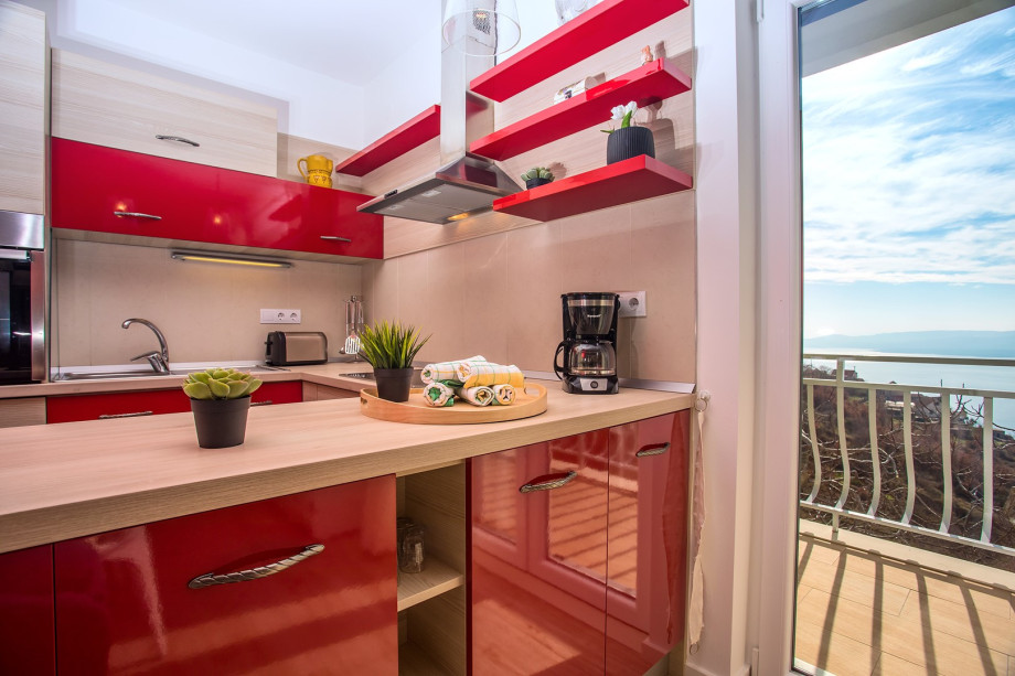 Fully equipped kitchen, spacious dining and living area with fireplace