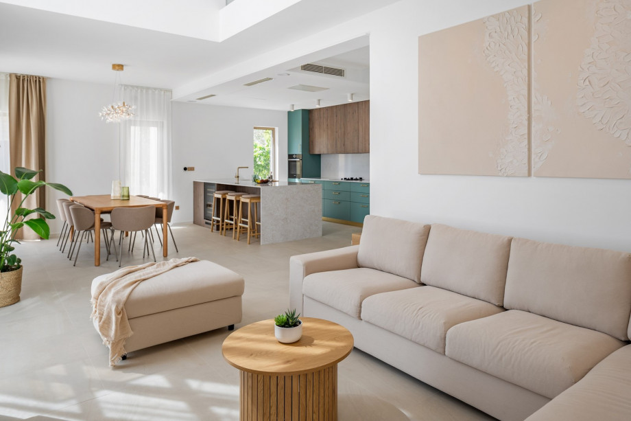 Living room offers a comfortable sofa with a flat-screen TV