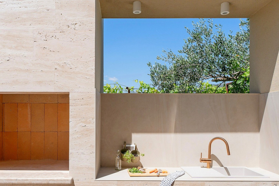 A barbecue area with a kitchen top and sink