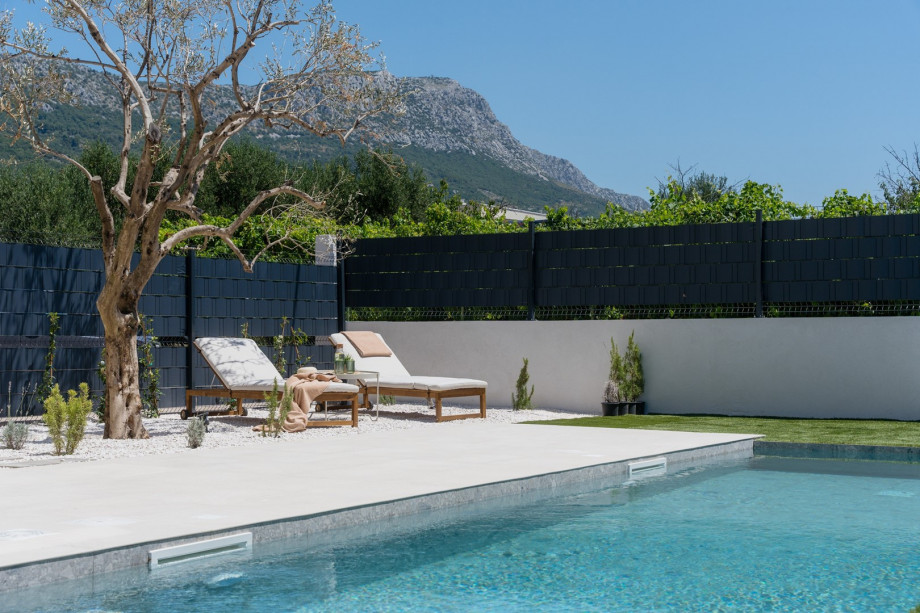 The sun deck area features six sundeck chairs, an outdoor shower