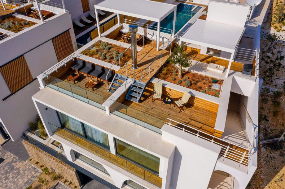 A cozy sitting area with spectacular, elevated views of the Adriatic sea, coast, and islands, together with pool views on the other side.