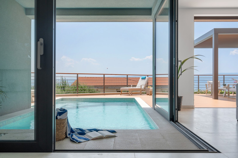 Dining room, and a living room is connected to the swimming pool and sunbathing area with sliding glass doors