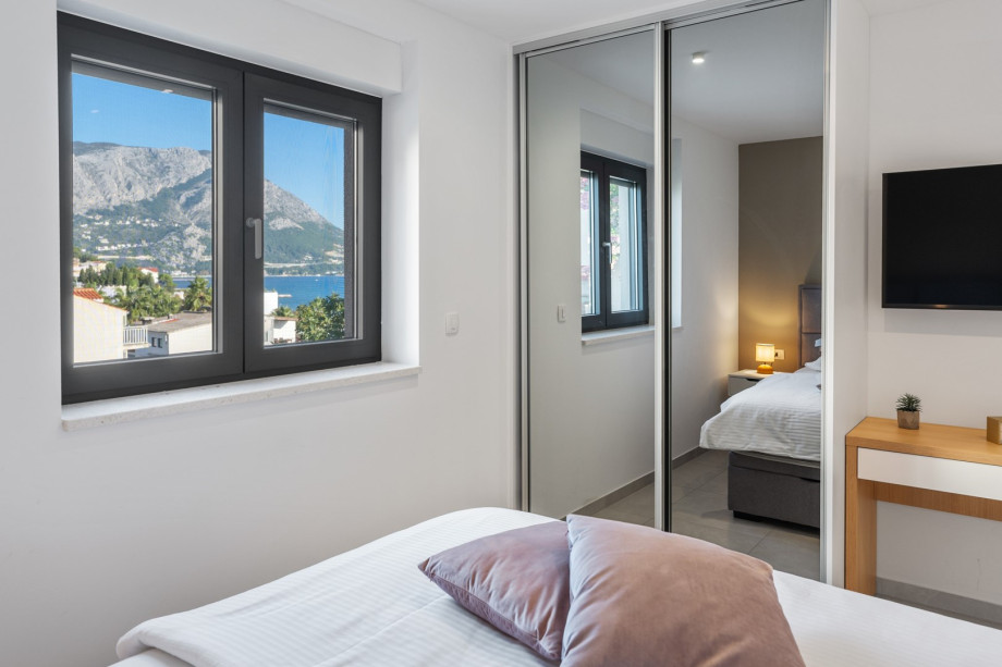 A Bedroom NO2  with a TV, A/C, en-suite bathroom with a shower, partial sea views