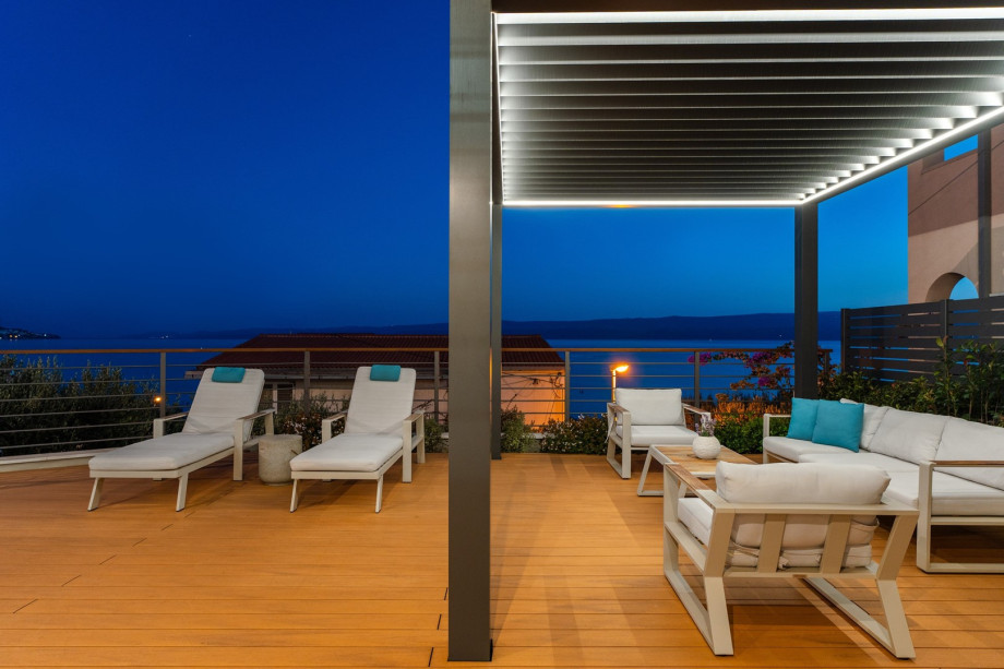 A sun-deck area with amazing sea views, 4 deck chairs, a covered lounge corner